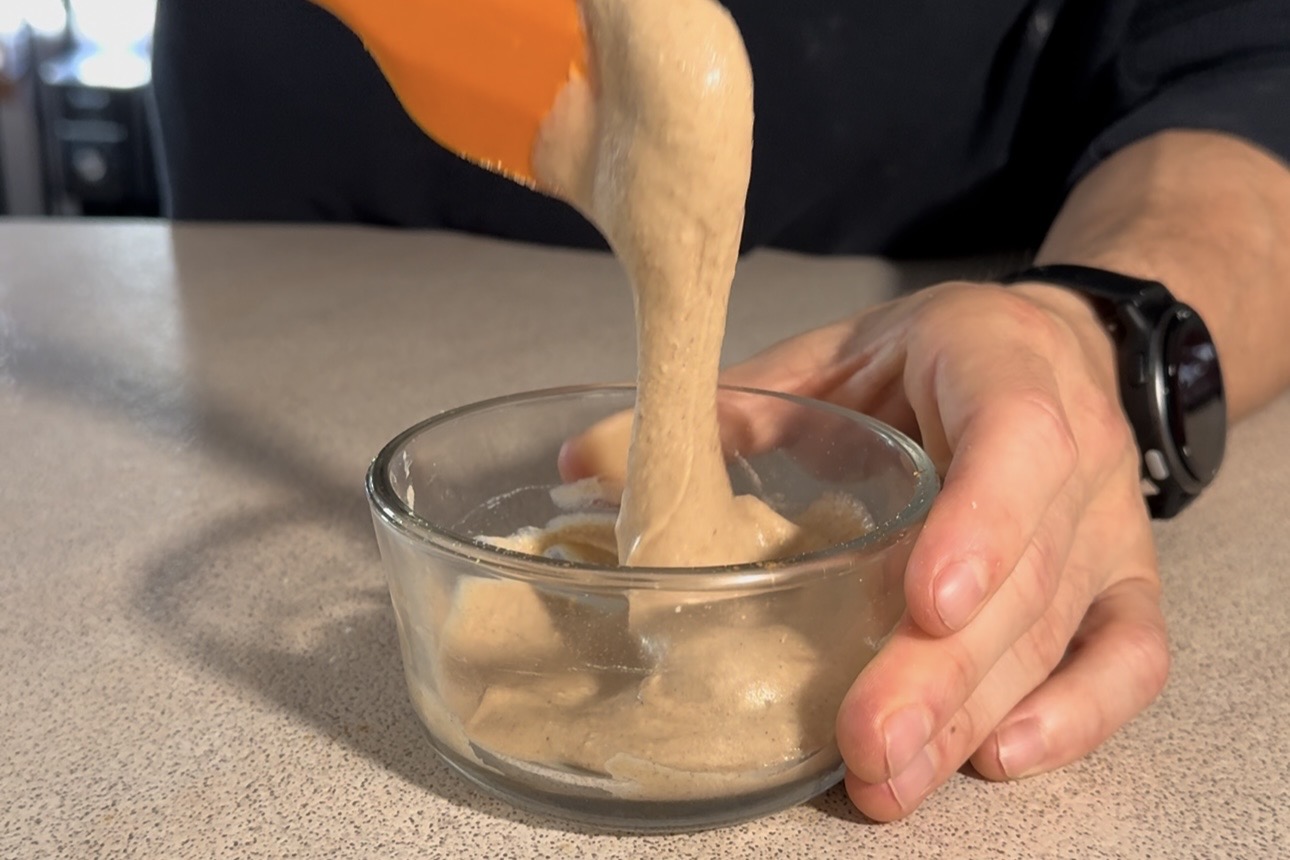 Vanilla protein frosting being mixed until smooth in a bowl